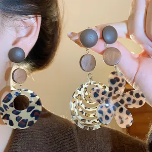 Retro Maillard leopard print wooden earrings with flower and circle cutout design details.
