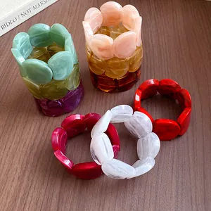 Close-up detail of colorful acrylic marbled bracelets featuring a unique circular splicing design