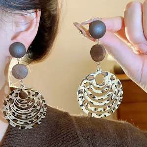 Detail view of vintage leopard print multi-tier circular drop earrings in brown tones