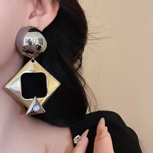 Detailed macro view of oversized geometric earrings with rhinestone on an Asian model