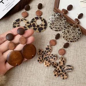 Detailed view of various retro earrings with wood and leopard print acrylic elements.