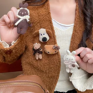 Detail showing cute flocked animal brooches pinned to a brown sweater for a cozy winter look
