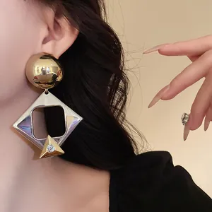 Close-up detail of oversized vintage geometric rhombus earrings with rhinestone accents