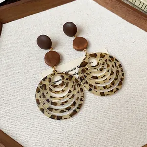 Close-up of vintage Maillard style wooden earrings with multi-layered leopard print