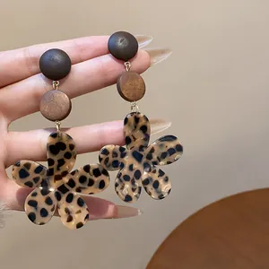 Close-up of vintage Maillard style wooden earrings with leopard print flower charms