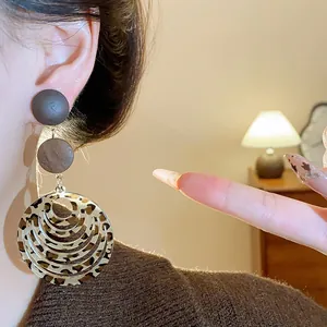 Detailed macro view of vintage Maillard style leopard print multi-layer dangle earrings