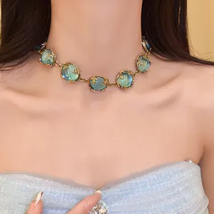 Vintage court style choker necklace featuring emerald green resin stones and gold-tone metal
