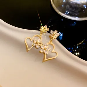 Elegant gold hollow heart earrings decorated with sparkling crystal flower clusters for women