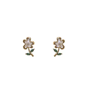 Elegant vintage flower stud earrings with gold stem and green leaves decoration