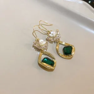 Elegant vintage drop earrings with white pearl flower and emerald green crystal