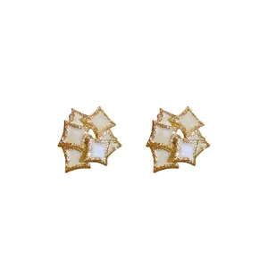 Elegant double-layered geometric square stud earrings with cream white enamel and gold border