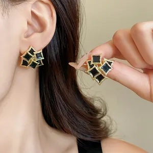 Detailed view of elegant double-layered square geometric earrings with black enamel finish