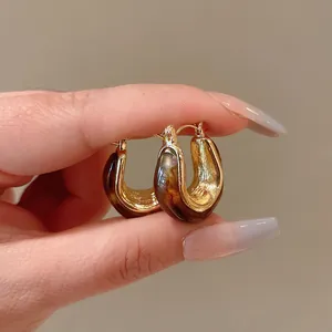 Vintage U-shaped hoop earrings with amber texture and gold finish detail