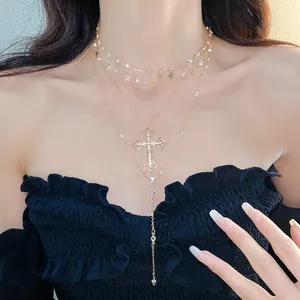 Elegant multi-layered gold-tone necklace featuring rhinestone cross and star charms