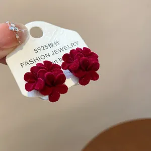 Close-up detail of red flocked flower stud earrings featuring S925 silver needles.