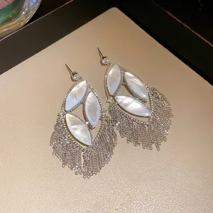 Elegant silver-tone zircon earrings featuring mother-of-pearl inlays and long tassel chains.
