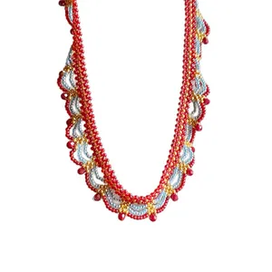 Vintage ethnic style beaded necklace with red and gold glass beads in wave pattern
