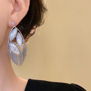 Detailed view of elegant silver tassel earrings featuring marquise mother of pearl and zircons