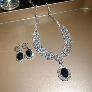 Elegant bridal jewelry set featuring oval black gems and sparkling crystals