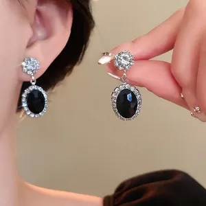 Elegant oval black stone earrings with sparkling zircon halo for weddings