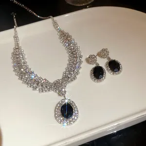 Elegant bridal jewelry set with black oval gemstone and sparkling cubic zirconia.