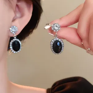 Elegant silver-toned oval dangle earrings with black stone and white zirconia