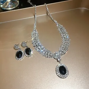 Detailed macro shot of sparkling bridal jewelry set with black oval stones and zircons.
