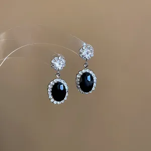 Elegant oval drop earrings with black faceted stone and clear zircon halo for weddings