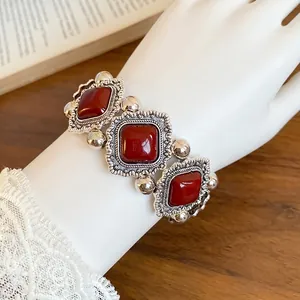 Elegant vintage palace style elastic bracelet featuring dark red rhombus stones on a wrist