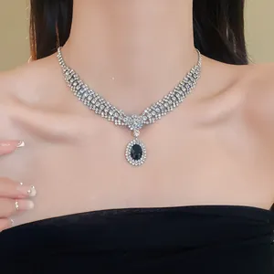 Close-up detail of a sparkly zircon oval pendant necklace worn by a bridal model