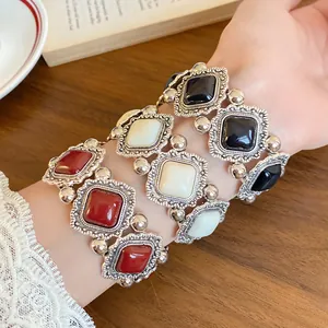 Detail of vintage court style elastic bracelets with ornate silver borders and stones.