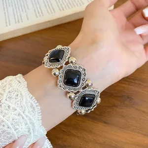 Close-up of vintage style elastic bracelet with black acrylic stones on wrist