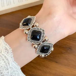 Vintage palace style silver-tone elastic bracelet with black acrylic square gems