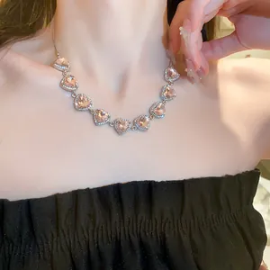 Detailweergave van een elegante roze hartvormige strass choker op een model.