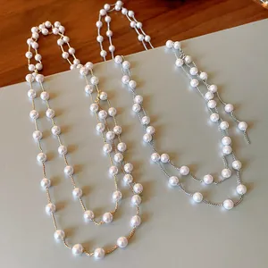 Detailed view of elegant French style long necklaces with white faux pearls for women