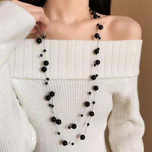 Elegant long sweater chain necklace featuring multi-sized black faux pearls for women