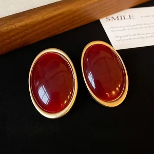 Vintage minimalist Ankara red oval stud earrings with gold rim and silver needle