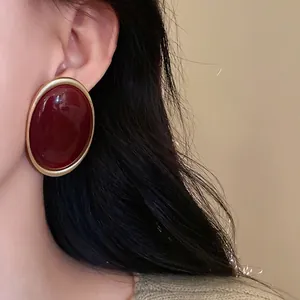 Vintage oversized oval stud earrings in glossy Andorra red with gold border