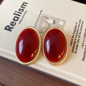 Vintage palace style oval stud earrings with deep red gems and elegant gold frames for women