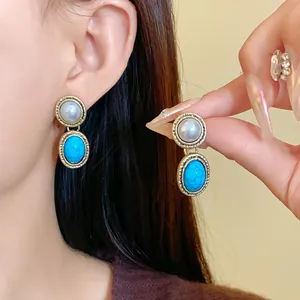 Close-up detail of vintage French style earrings featuring pearls and blue turquoise stones