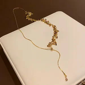 Detailed view of the golden wheat spike sequins and tassel on fashion clavicle chain