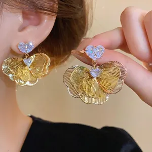 Elegant gold plated flower petal stud earrings featuring heart shaped cubic zirconia accents