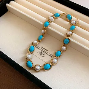 Detailed macro view of French vintage necklace with faux pearls and turquoise stones