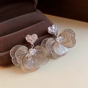 Elegant silver-plated flower earrings with sparkling heart-shaped cubic zirconia detail