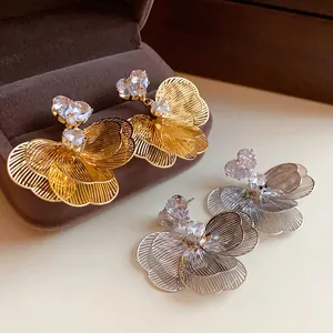 Detailed view of floral zircon earrings with heart-shaped crystals and filigree petals