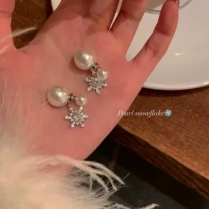 Elegant pearl snowflake earrings with sparkling crystals for a festive winter look