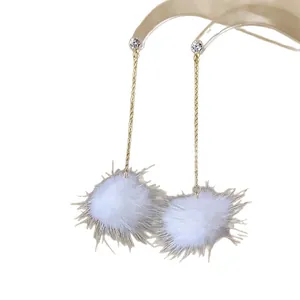 Elegant winter white fluffy pom-pom drop earrings with gold chain and sparkling crystal accents