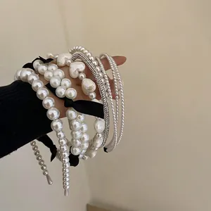 French style white faux pearl headband set with sparkling rhinestones and black bows