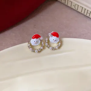 Detailed view of festive Santa Claus stud earrings with pearls and sparkly rhinestones