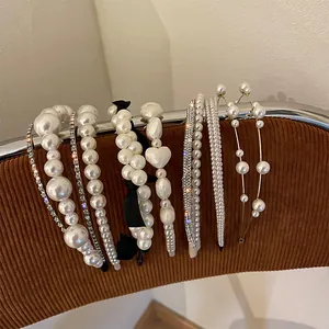 Detailed view of various vintage French pearl headbands with bows and rhinestones.